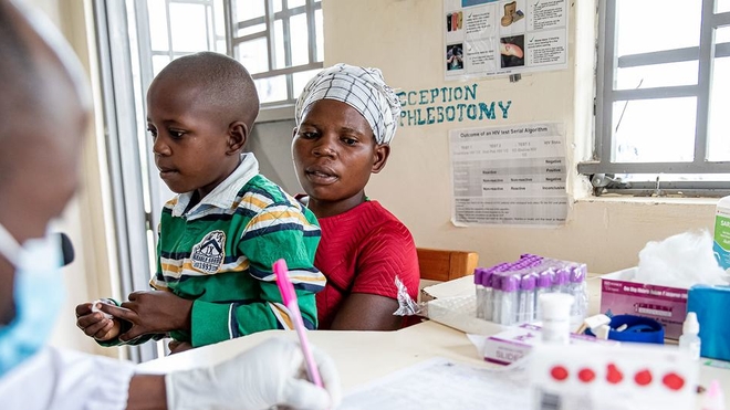Une mère et son fils de neuf ans, tous deux séropositifs, se rendent dans un dispensaire à Mubende, en Ouganda